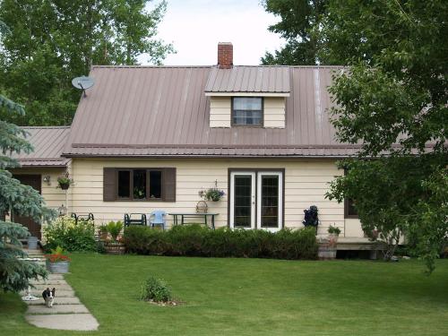 A home maintenance inspection plan helps homeowners keep on top  of repairs before they become issues. photo of mid 60s home metal roof not new home but well kept.