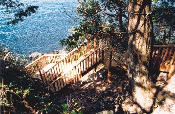 steep hillside  with well built and maintained stair set Very typical rocky steep lot in Muskoka, Port Carlng and Bala. All stairs should be subject to a home inspection.