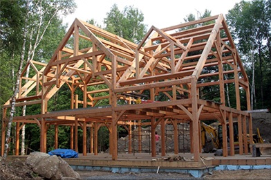 Timber bents ,and crosbeams in place this framing job is well under way. Port Carling has several  hundred plus year old  comercial buildings built with bents like these.